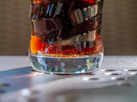 Glass of soda with a swirl pattern on the side photo