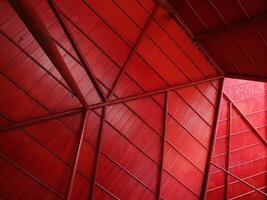 Bottom view rustic steel roof in red color geometric background for aesthetic modern minimalist retro concept photo