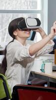 Joyful young businesswoman immersed in virtual reality with 3D VR glasses video