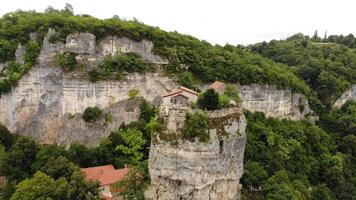 Orthodox monasteries perched on rocky cliffs or isolated rock formations, showcasing spiritual heritage, ancient architecture, and breathtaking natural surroundings. video