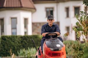 Sitting, on ,,the lawn mover,,,. Professional gardener is on the lawn photo