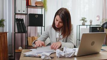Angry furious businesswoman working at home office throwing crumpled paper having nervous breakdown at work migraine, stress management, mental distress problems, losing temper, reaction on failure. video