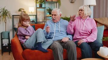 Irritated grandfather and grandmother scolding granddaughter for bad behavior and disobedience on sofa, raising voice, scream at little grandchild. Difficulties of upbringing, misbehaved child concept video
