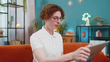 Surprised Caucasian man guy using laptop computer, receive mail good news message, wow shocked by sudden victory celebrate lottery jackpot win purchases online shopping at home on sofa. Lifestyles. video