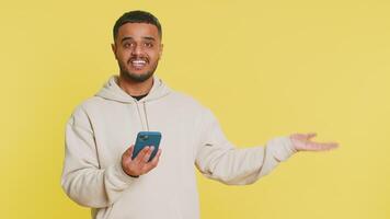 Man use smartphone typing new post on web, browsing searching, addiction of social networks, positive feedback, recommends Wi-Fi cellular connection 5G showing pointing empty place, advertising area video