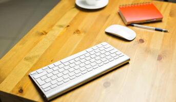 Desk accessories desktop, keyboard, computer mouse on wooden oak table photo