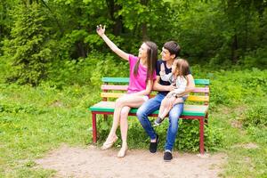Happy family in the park taking selfie on a sunny day photo