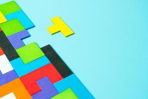 geometric shape block with colorful wood puzzle piece background. logical thinking, business logic, Conundrum, decision, solutions, rational, mission, success, strategy concepts photo