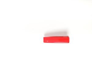 Minimalist shot showcasing a vibrant red rectangular object on a crisp white surface photo