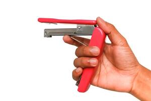 Conceptual image depicting the use of a red stapler held like a pistol on a white background photo