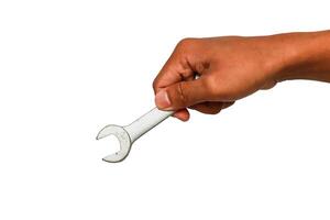Close-up of a hand holding a wrench against a clean white background, showcasing precision and craftsmanship photo