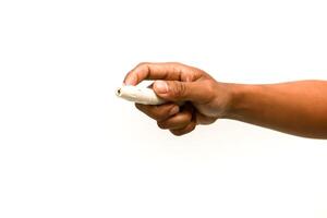 Close-up of a hand holding a lancing device for blood sugar testing on white background photo