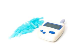 Close-up of a Glucose Meter and Lancets for Diabetes Testing on White Background photo