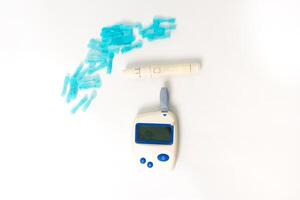 Glucose monitoring kit, including meter, lancing device, and lancets, on a white background, essential tools for diabetes management photo