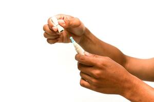 Close-up of hands preparing a lancing device for blood glucose level testing photo