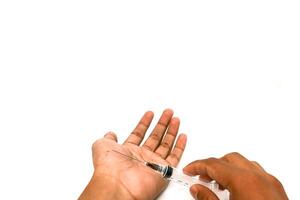 Close-up of hands injecting with a syringe on a white background in the studio photo