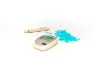 Diabetes monitoring kit featuring a glucometer, lancing device, and lancets displayed on a bright white surface for medical diagnostics photo