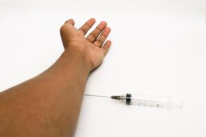 Conceptual image of syringe injecting medication into a human arm on white background photo