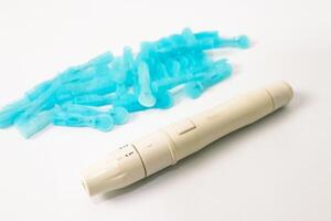 Close-up view of a Glucose meter with lancets for diabetes self-testing equipment, medical instrument, healthcare and preventing disease photo