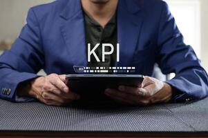 Professional Man Evaluating KPI Performance Indicators on Tablet photo