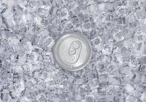Top view. Aluminum soda can with water drops on ice cubes. Summer refreshing drink photo