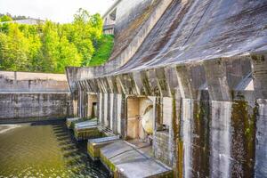 Constructed on the Vltava River, the Orlik Dam generates renewable energy while providing stunning views of nature. Surrounding greenery enhances the area's beauty during the day. photo