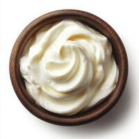 Creamy whipped sour cream in wooden bowl isolated on white background photo