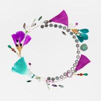 Handmade bijouterie garland with gems and feathers, white square background photo