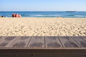 Empty wood tabletop on the beach with blue sky photo