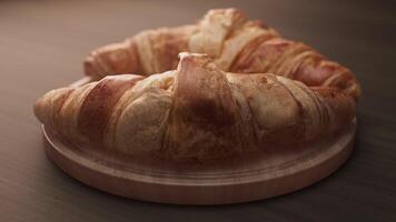 Looping animation around a composition of two croissants lying on a wooden board video