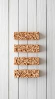 Four Gluten Free Bars Laying Flat on White Wood Surface. Low Carb Sweet Food Concept for Diet. Delicious Dessert Arrangement. photo