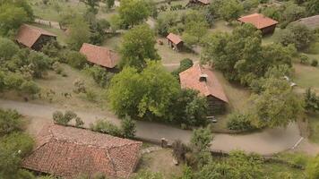 Aerial tilt up view old Traditional Georgian architecture wooden houses towers displayed in Giorgi Chitaia Open Air Museum of Ethnography in Tbilisi. Cultural heritage site on Tbilisi hills Vake video