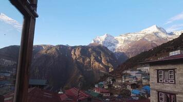 POV Guesthouse window to Namche Bazaar town in Khumbu Pasanglhamu Rural Municipality in Solukhumbu District. Khumbu valley stays. Typical traditional houses and Nepalese culture video