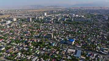 Aerial footage of a residential area in Bishkek, Kyrgyzstan, summer 2024. Shows apartment buildings and mountainous backdrop. Ideal for urban and cultural projects. video