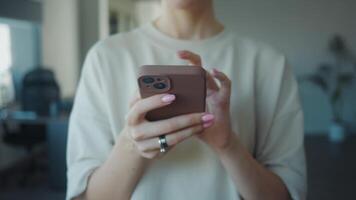Woman using smartphone at home, browsing internet on mobile phone, close up of hands holding mobile phone, checking social media, reading news, online shopping. Concept using smartphone video