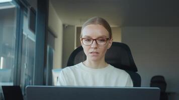 Marketing coordinator It works at computer serves customers. Office worker concentrating intently on laptop, skillfully completing tasks in modern workspace designed for productivity and efficiency video
