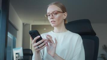 Woman recruitment manager, using smartphone to browse the internet, engage with social media, check emails, and maintain connections throughout day. Search for workers recruitment manager video