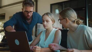 Workplace training for office employees, engaging in a discussion around laptop, fostering teamwork and problem solving in a professional environment. Command training of office personnel video