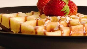 Waffle with strawberries and chocolate drizzle. video