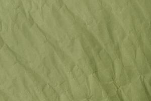Abstract green wrinkled crumpled paper texture background photo