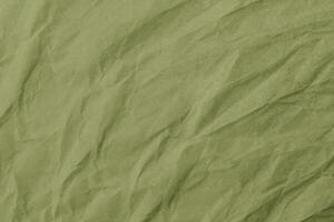 Abstract wrinkled green crumpled paper texture background photo