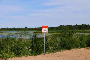 Warning Sign Near Wetlands Please help us preserve the vital natural habitats and ecosystems photo
