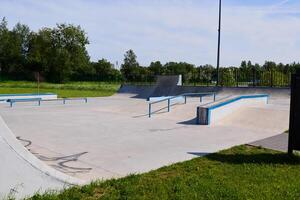 A Vibrant Skatepark Featuring Ramps and Rails Under the Radiant Sun on a Perfect Day photo