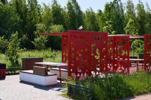Modern Outdoor Pavilion Featuring an Artistic Design Set Amidst a Lush Green Environment photo