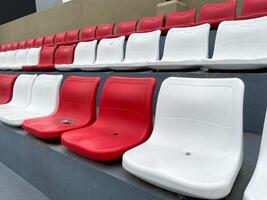 Empty Red and White Stadium Seats A Glimpse into a Quiet Stadium photo