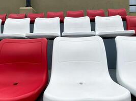 Rows of Red and White Stadium Seats Awaiting Spectators photo