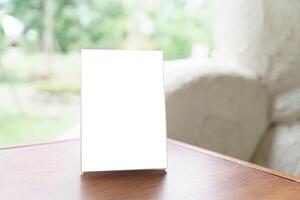 a Menu mock up blank white card on a table in front of a window photo