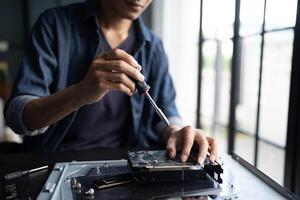 Engineer installing Hardware. man is working on a computer with a screwdriver photo