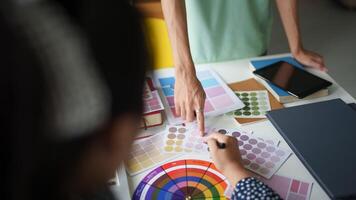 a woman is working on a color palette with a tablet working together photo