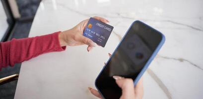 a woman using a credit card to pay for a meal at a restaurant photo